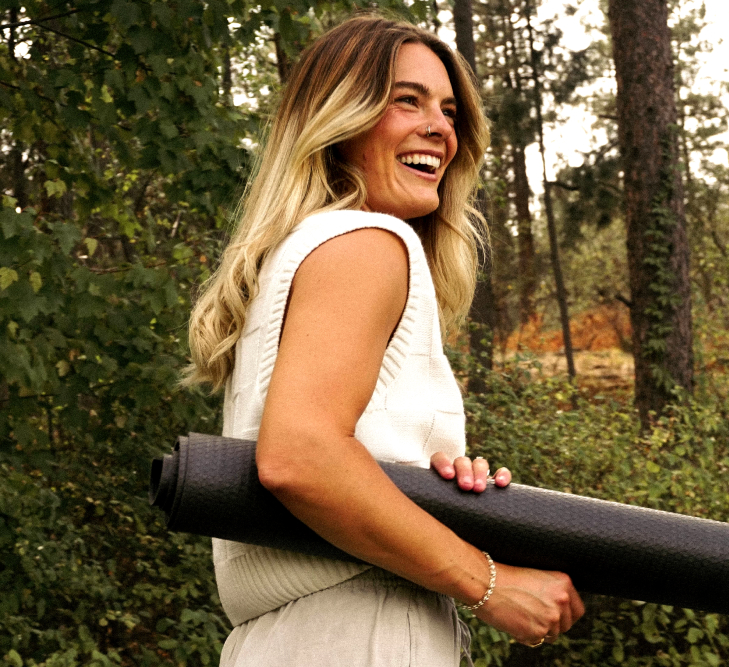 Girl carrying a yoga mat under her arm